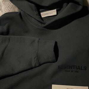 Essentials Fear of God hoodie in Black Limo. Comfortable and stylish.